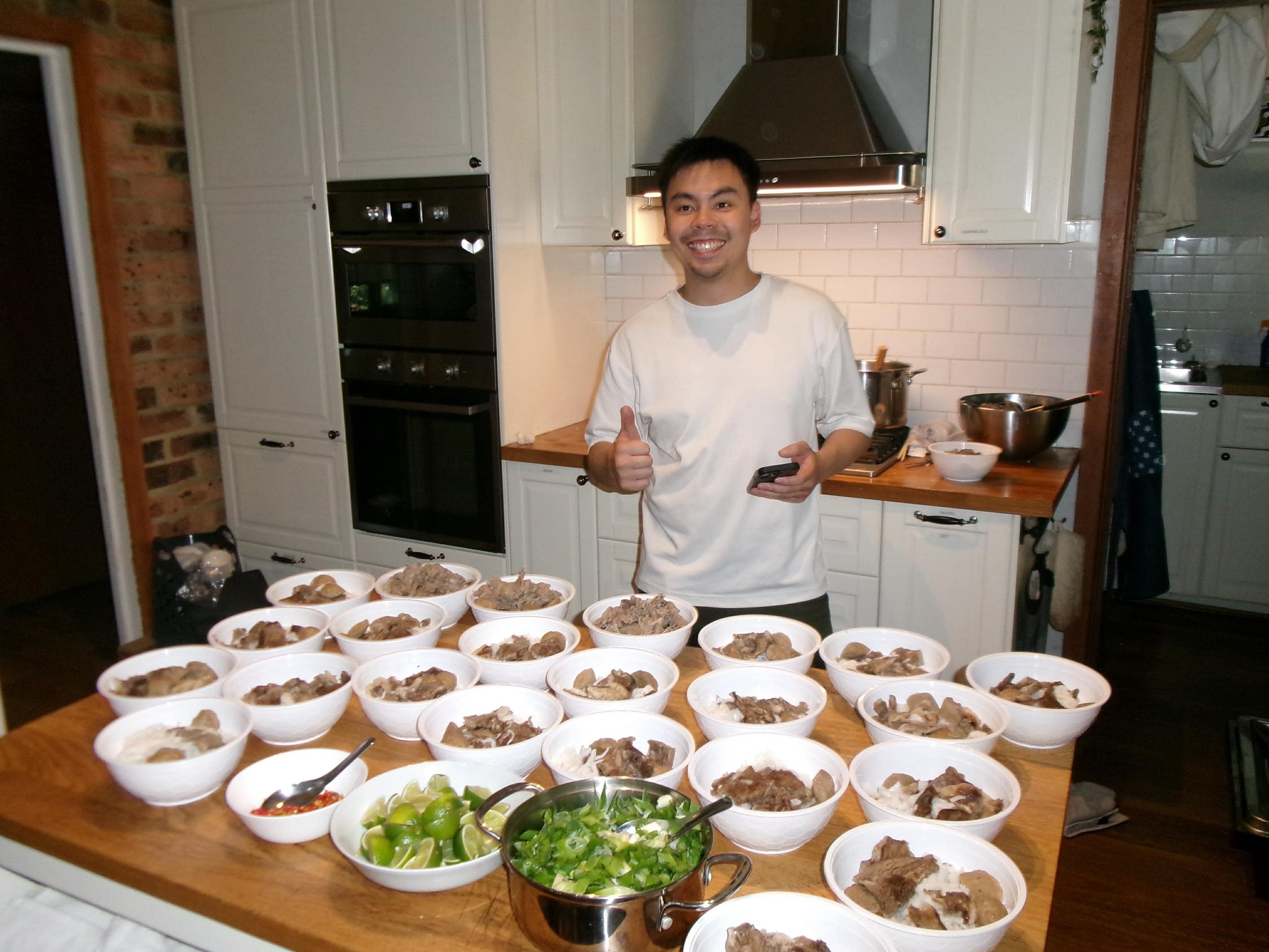Kevin reheating pho in a kitchen